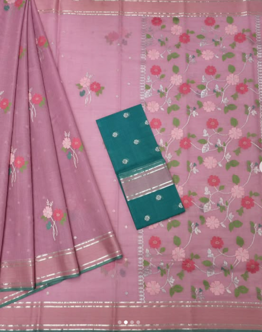 Pink saree with floral patterns and a green border on a matching pink background